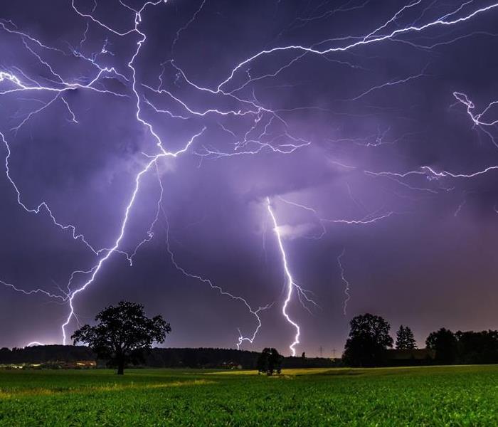 night sky with heavy lightning strikes hitting the ground